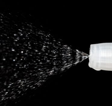Water Spray Nozzle spraying water with a black background behind it.