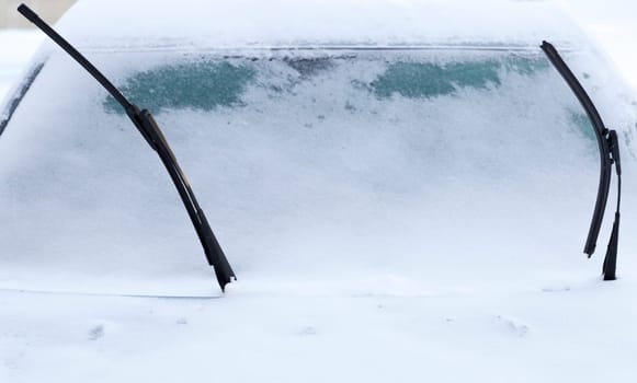 Windscreen Wipers on Snowy Car in winter time.