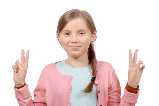 young girl showing her hands by doing victory gesture on white background