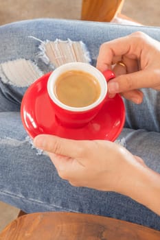 Woman in torn jeans sitting at coffee shop, stock photo