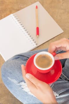 Woman in torn jeans sitting at coffee shop, stock photo