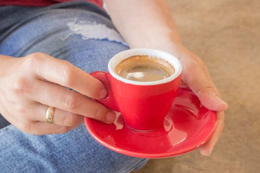 Woman in torn jeans sitting at coffee shop, stock photo