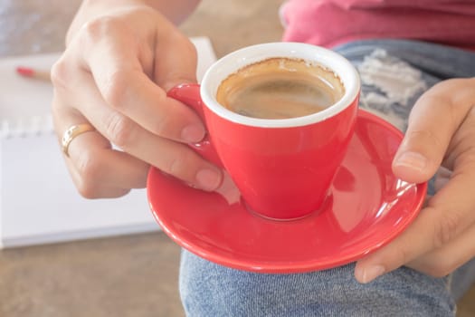 Woman in torn jeans sitting at coffee shop, stock photo