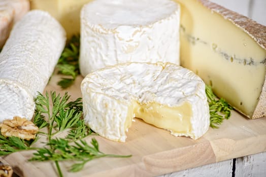 different french cheeses placed on old  table