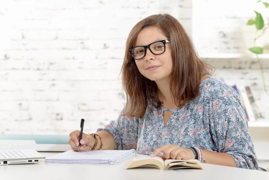 a teenage girl student working on his homework