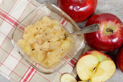 applesauce with some apples in the background