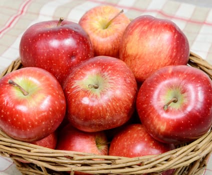 Several red apples in a basket wicker