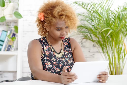 young African woman looking at a digital tablet