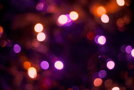 Christmas decoration lights with blur effect, holiday party background. Ideal for greeting card, event invitation or web backdrop.