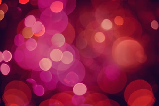 Defocused blur lights background, closeup in red color with bokeh effect. Ideal for holiday greeting card, event, or web backdrop.   .