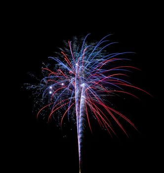 A single and colorful fireworks over a night sky isolated on black background