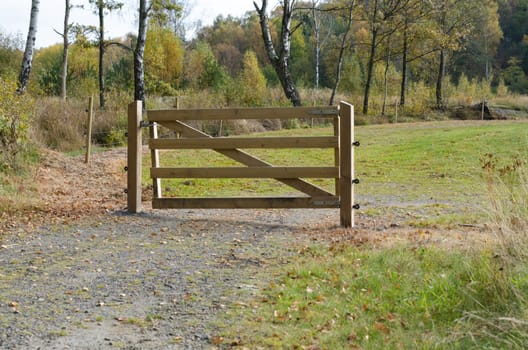 a gate of wood to protect the golfcource from animal