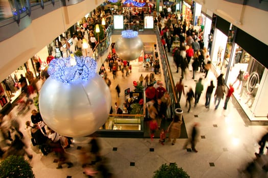 People Shopping For Christmas In Luxury Shopping Mall Interior. Low motion shot