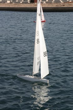 BARCELONA, SPAIN - DEC 29, 2007: People racing remote controlled sailing wooden yachts at Forum Port