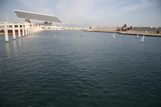 BARCELONA, SPAIN - DEC 29, 2007: People racing remote controlled sailing wooden yachts at Forum Port