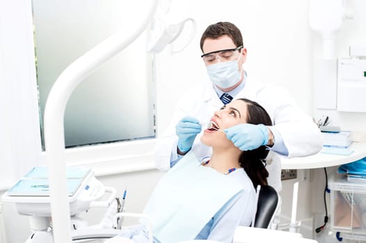 Dentist treating a patient in clinic