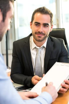View of a Attractive boss doing interview with his assistant
