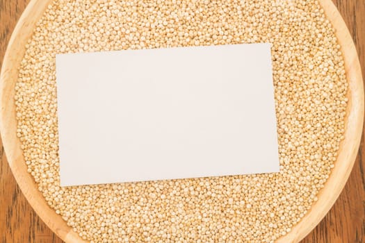Organic quinoa grain and business card, stock photo