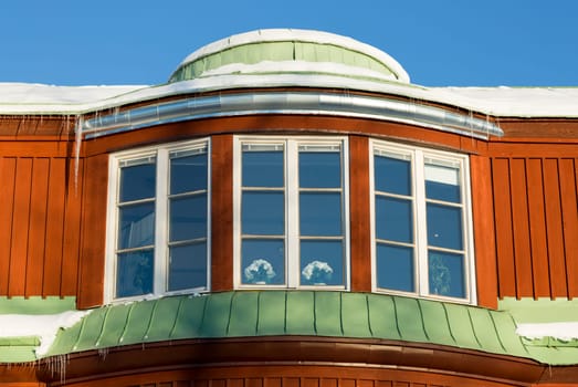 Building with Icicles and Snow with a clear blue sky.