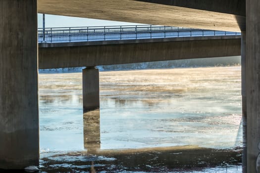 Mist on Icy River under Bridge in Umea, Sweden