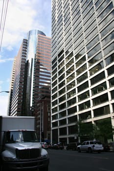 New York delivery truck by a city street scene with the skycrapers at bottom