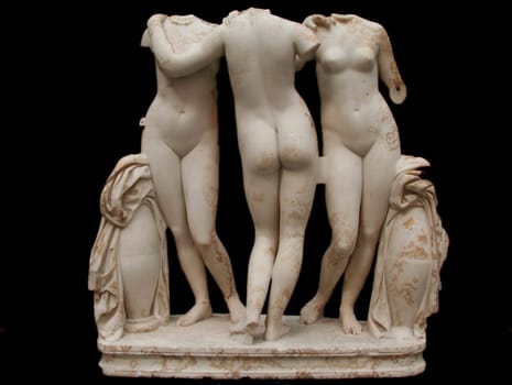 Classic white marble statue of Three Graces, isolated on black background