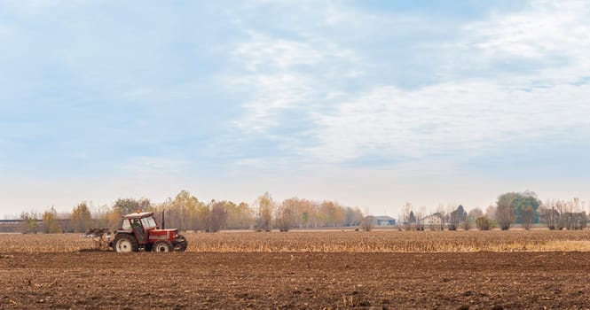 Tractor plowing a field with a plow.