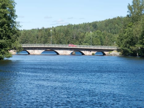 old stonebridge over the lake one car on the bridge