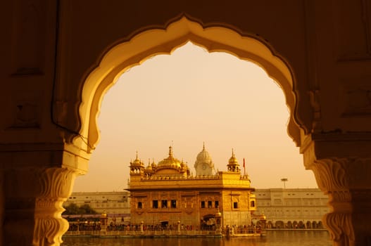 Amritsar Golden Temple - India. Framed with windows from west side. focus on temple