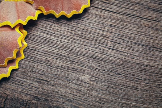 yellow shavings on wooden background. Space for text.