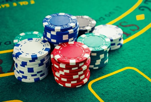 chips for poker on green playing table