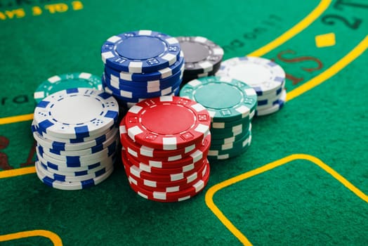 chips for poker on green playing table