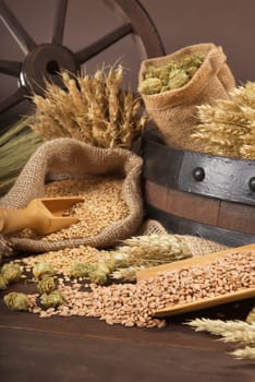 Beer barrel,wagon wheel with wheat,barley,hops and malt