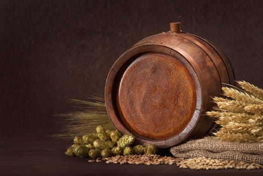Old barrel with wheat,barley,hops and malt