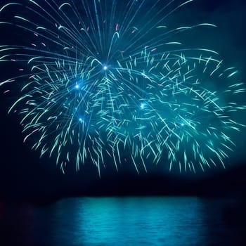 Blue fireworks on the black sky background