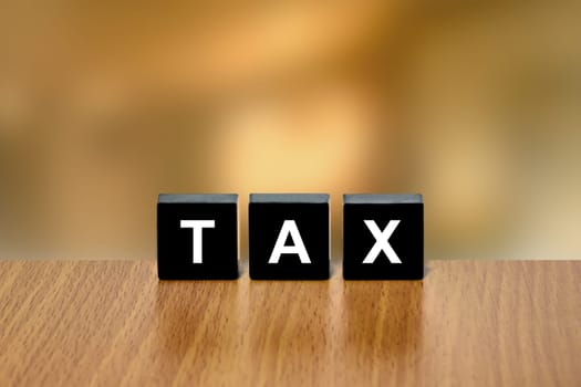 accounting tax on black block with blurred background
