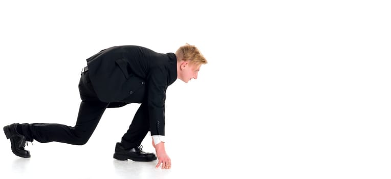 young businessman in black suit in start position