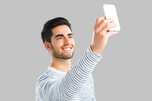 Young man sending a text message, isolated on white background