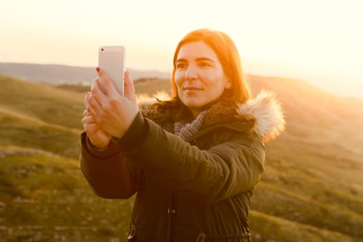 Beautiful woman in outdoor making a selfie