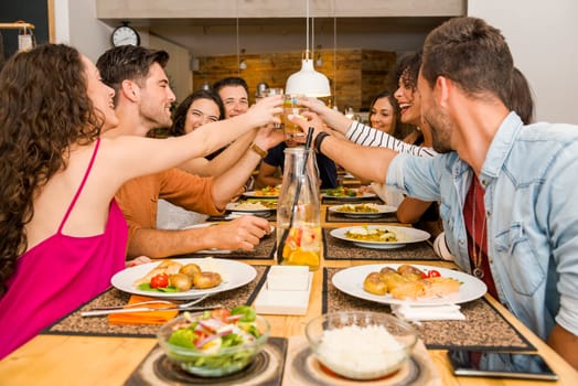 Multi-Ethnic Group of happy friends lunching and tasting the dessert at the restaurant