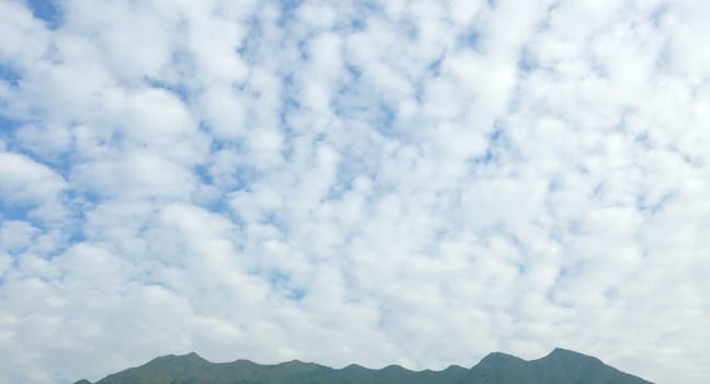 blue sky, textured cloud and mountain