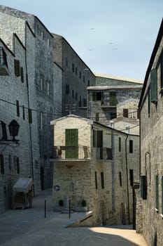 Tuscany old town detail. Group of stone made houses on street.