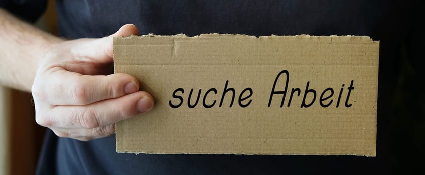 Cardboard sign with the inscription "seek work"""