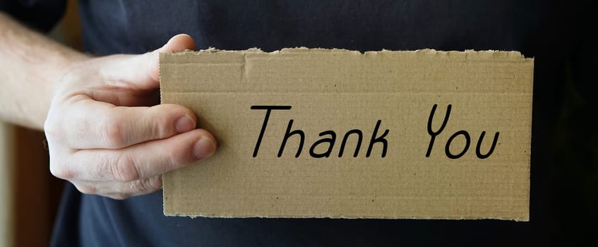 Cardboard sign with the inscription "Thank you"""