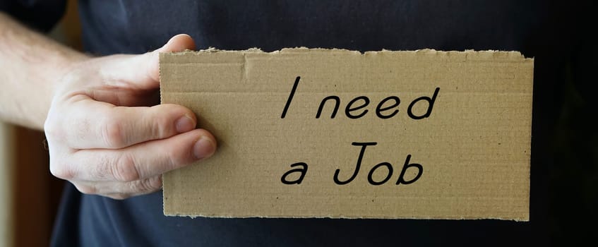 Cardboard sign with the inscription "seek work"""