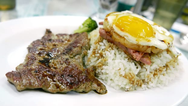 beef, egg, pineapple rice on the white dish