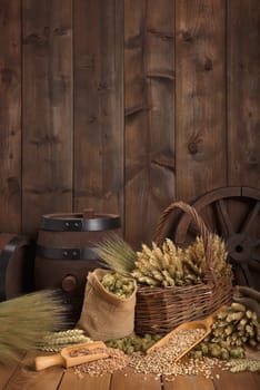 Old beer barrel with wheat,barley,hops and malt