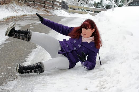 Risk of accident in winter - A woman has slipped on a snow-smooth road