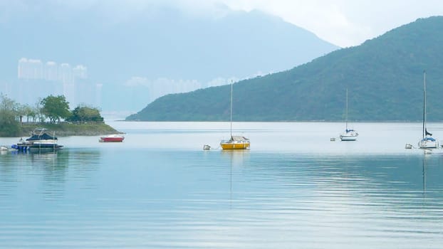 few sailboats on the peaceful lake