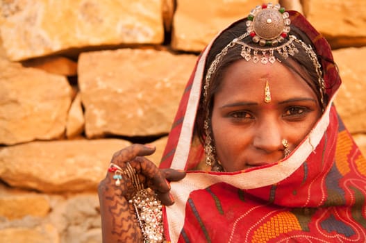 Traditional Indian woman in sari costume covered her face with veil, India
